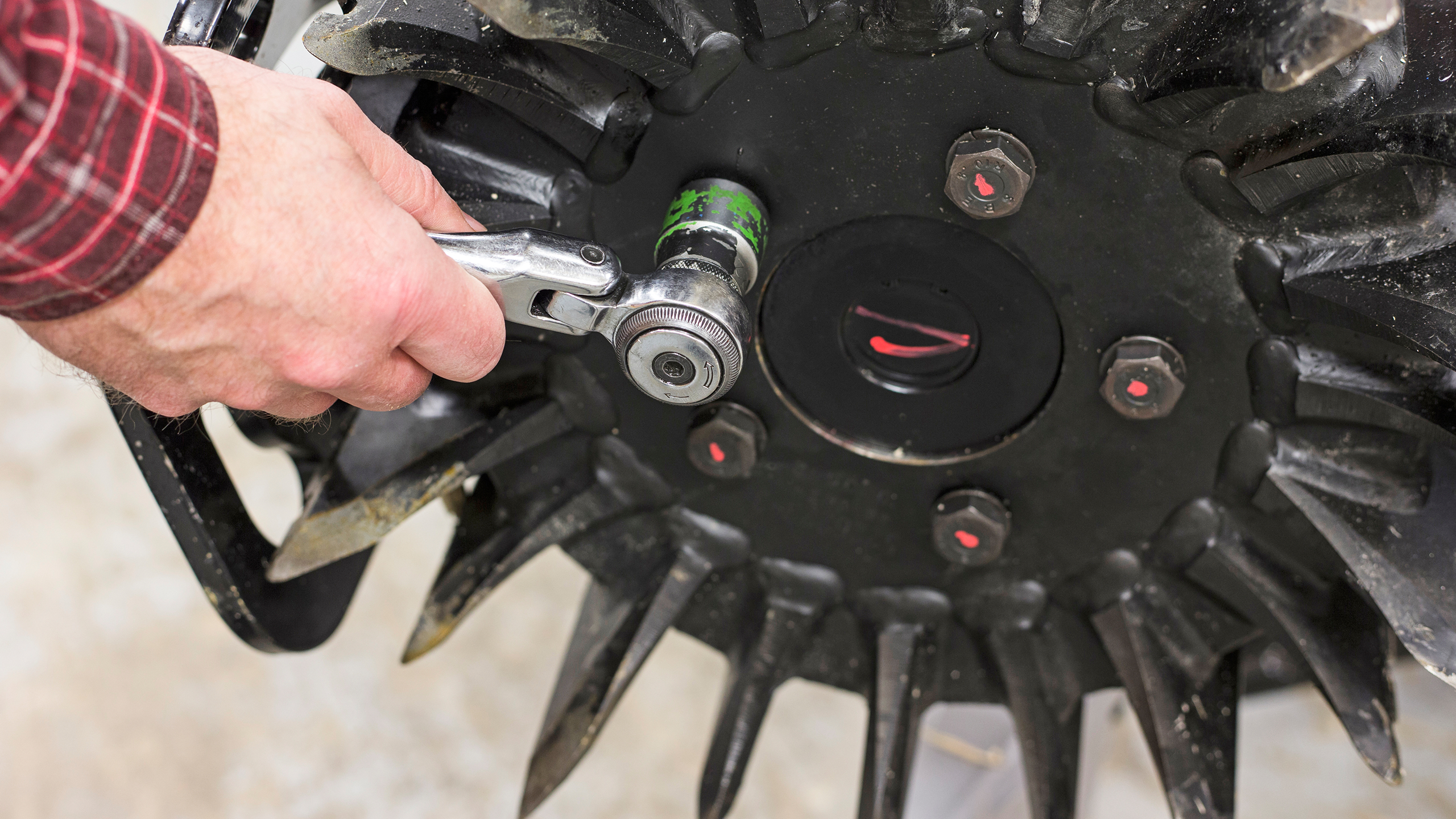 Hands performing feed roller service